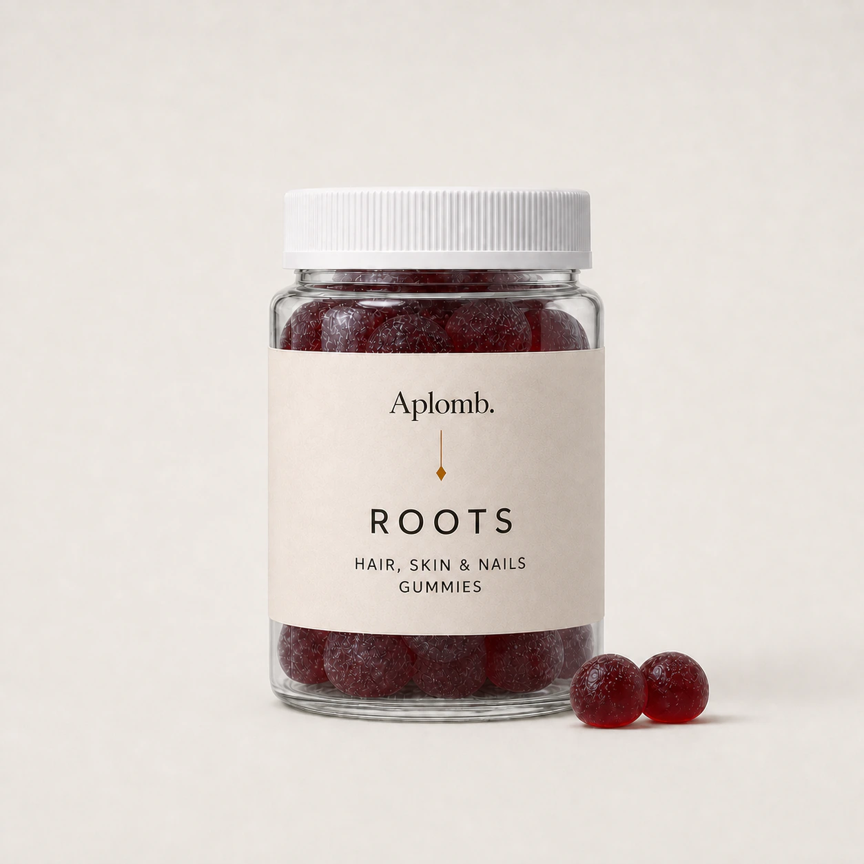 APLOMB Roots hair-support gummies bottle with two red gummies