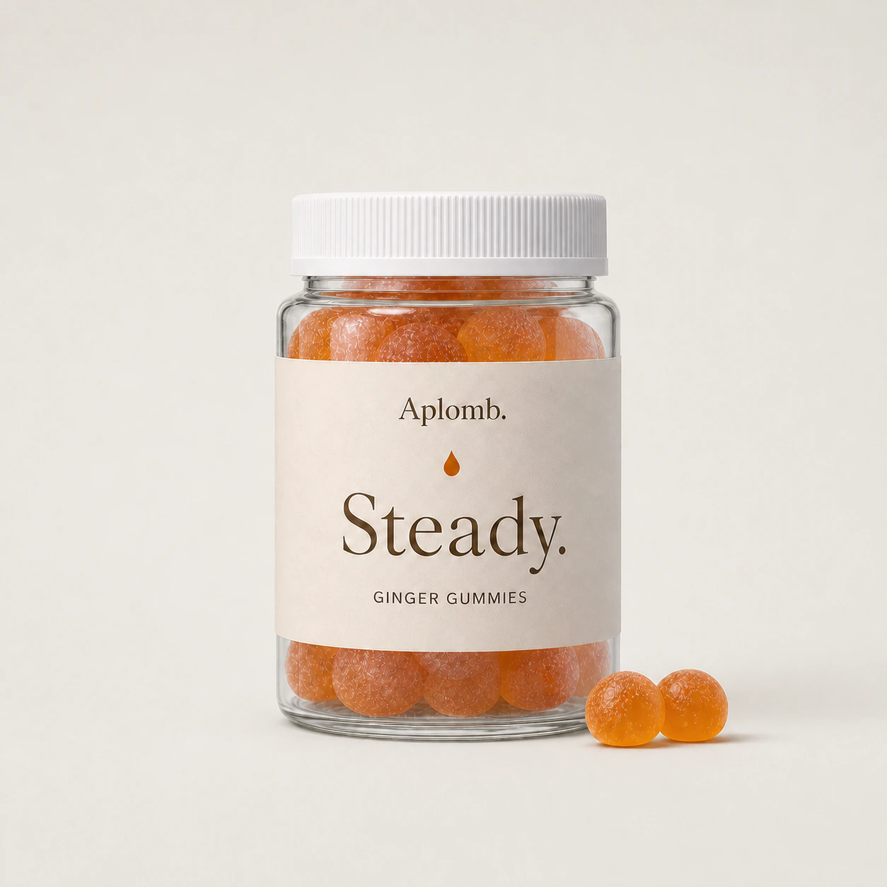 APLOMB Steady ginger gummies bottle with two orange gummies